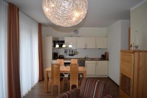a kitchen with a wooden table and a dining room at Villa Carina "Carina`s 911" in Baabe