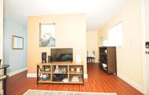 a living room with a flat screen tv at Cozy Canaveral Beach Condo! Next to NASA Launch Site in Cape Canaveral
