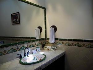 a bathroom with a sink and a mirror at Hotel Casa Madeleine B&B & Spa in Antigua Guatemala