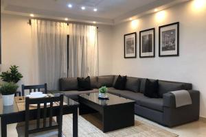 a living room with a couch and a table at Luxury Apartment in Awesome Location in Amman in Amman