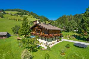 an aerial view of a house in a green field at Bauernhof Auhof in Wagrain