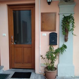 a door to a house with a plant next to it at Casa Marta in Cividale del Friuli