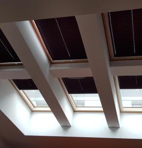 four skylights in a ceiling with black solar panels at Old Town, Kazimierz, large luxurious, 2 bedroom 2 bathroom, Airco in Krakow