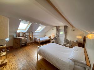a bedroom with a bed and a desk in a attic at Quaint 4 Bed Barn Conversion Barnhouse Starshinezz in Trimdon Grange