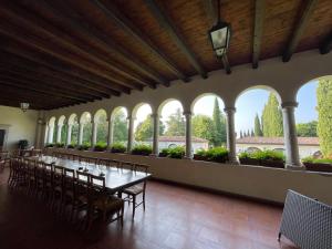 a long dining room with a long table and chairs at Relais Villa Selle in Fumane +78 photos