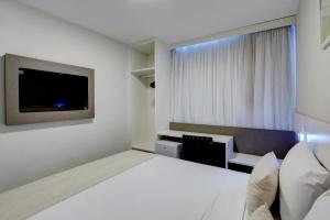 Uma cama ou camas num quarto em Go Inn Contagem - MG