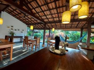 a dining room with a wooden table and chairs at Porto do Meio in Arraial d'Ajuda