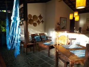 a dining room with wooden tables and chairs at Porto do Meio in Arraial d'Ajuda