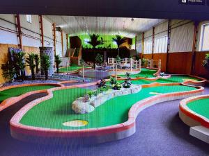 a room with a miniature golf course in a building at Penzion Rozkoš in Pruhonice