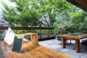 a patio area with chairs, tables, and a bench at TRUNK (HOTEL) in Tokyo