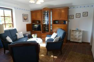 a living room with blue couches and a table at Carpe Diem III 1323 in Landkirchen