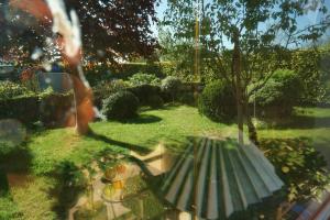 a reflection of a person sitting on a bench in a garden at Carpe Diem III 1323 in Landkirchen