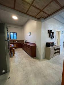 a large kitchen with a refrigerator and a table at Coral View Hotel & Resort in Caye Caulker