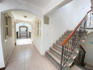 a hallway with a staircase in a house at Hotel Dulce Luna in San Cristóbal de Las Casas