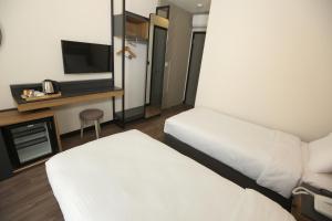 Кровать или кровати в номере Moja City Hotel