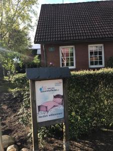 a sign in front of a house at Ferienhaus auf dem Hof in Wanna