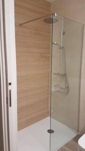 a shower in a bathroom with a glass door at La Rua 25 in Castro-Urdiales