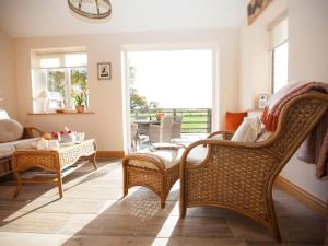 a living room with a couch and chairs and a table at Deerholme Cottage in Malton