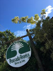 a sign for a pucola morocco cafe and shop at Pousada Aroeira in Barra do Sahy