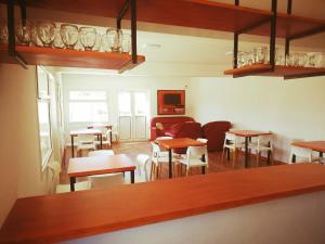 a room with tables and chairs and a couch at Raíces in Puerto Pirámides