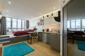 a kitchen and living room with a large window at Mini-Smart 2 in Kyiv
