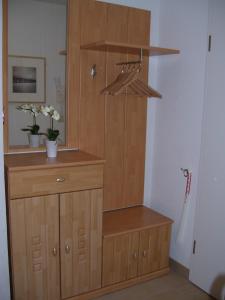 a wooden cabinet with a dresser in a room at Reiseoase Kavelweg 10, Whg 2 in Zingst