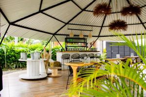 a tent with chairs and tables in a garden at Orange Eco Villas in Quimbaya