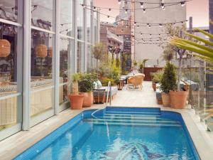 a swimming pool on the roof of a building at Mondrian London Shoreditch in London