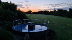 a small pond in the middle of a field at Hotel & Pension Haus Dewenter in Lichtenau