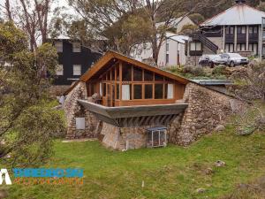 a house that is on top of a hill at Wombiana in Thredbo