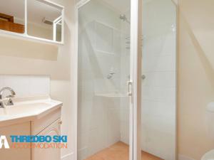 a bathroom with a shower and a sink at Wombiana in Thredbo
