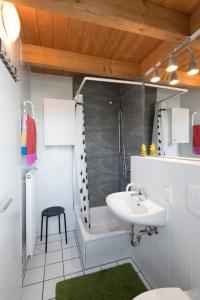 a bathroom with a sink and a shower and a toilet at Fewo Nachbaur Typ B in Oberjoch