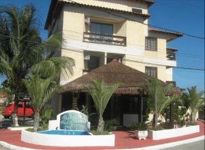 a large building with a sign in front of it at Hotel Pousada Laje de Itauna in Saquarema