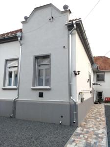 a house with pipes on the side of it at Jade Vendégház in Pápa