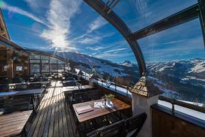 a restaurant with a view of the mountains at Gasthof Ochsalm in Kirchberg in Tirol
