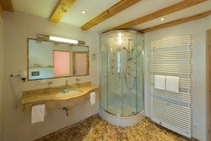 a bathroom with a shower and a sink at Gasthof Ochsalm in Kirchberg in Tirol