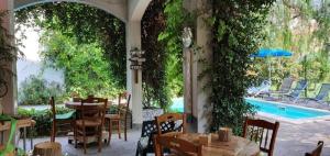 a patio with tables and chairs and a swimming pool at B&B Il Sognatore in Perugia