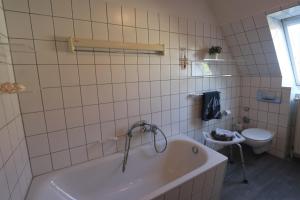 a bathroom with a tub and a toilet at Kranichrast 1 Whg 4 in Zingst