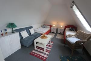 a living room with a couch and a bed at Kranichrast 1 Whg 4 in Zingst