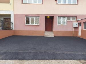 a building with a parking lot in front of a door at New apartment Old town with free parking in Sarajevo