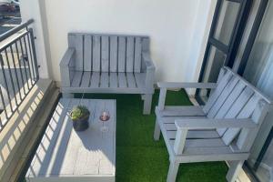 a balcony with two benches and a potted plant at The Blyde Silverlakes in Boschkop +1 photo