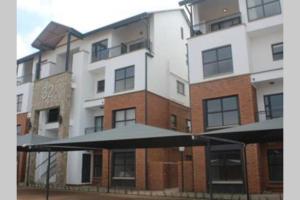 a large apartment building with a large building at The Blyde Silverlakes in Boschkop