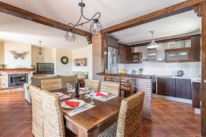 a kitchen and living room with a wooden table and chairs at Villa Natalia in Nerja