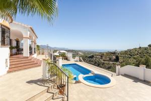 a villa with a swimming pool on a patio at Villa Natalia in Nerja