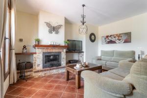 a living room with a couch and a fireplace at Villa Natalia in Nerja