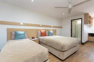
a hotel room with a bed and a desk at Broome Time Resort in Broome
