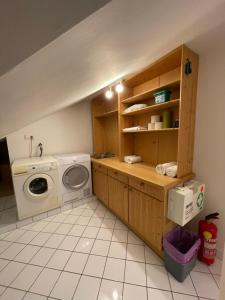 a laundry room with a washing machine and a washer at undertheroof at in Salzburg