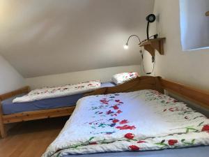 a bedroom with two beds with flowers on the sheets at Ferienhaus "Spatzennest" Eifel Gerolstein Hunde ok in Oberbettingen