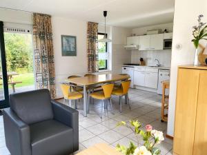 a kitchen and dining room with a table and chairs at Hello Zeeland - Vakantiehuis Stern 202 in Breskens