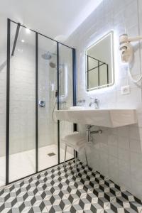 a bathroom with a sink and a shower at Hotel Beau Site - Rocamadour in Rocamadour